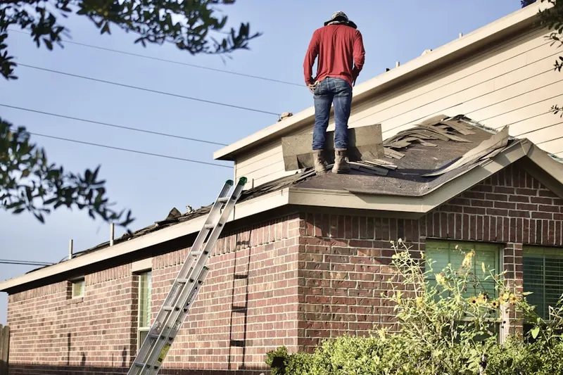 Professional roofer working on a residential roof in Crawford